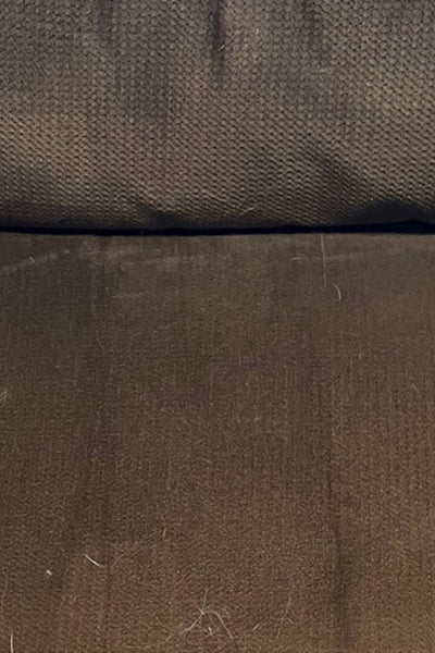 A brown couch cushion that's completely clean, no hair in sight.